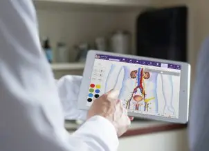 Doctor Using Urology-Specific EHR Touchscreen