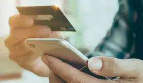 Person scanning credit card with phone