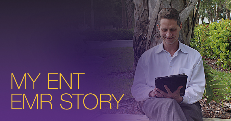 male physician in white shirt sitting under a tree with an iPad EHR