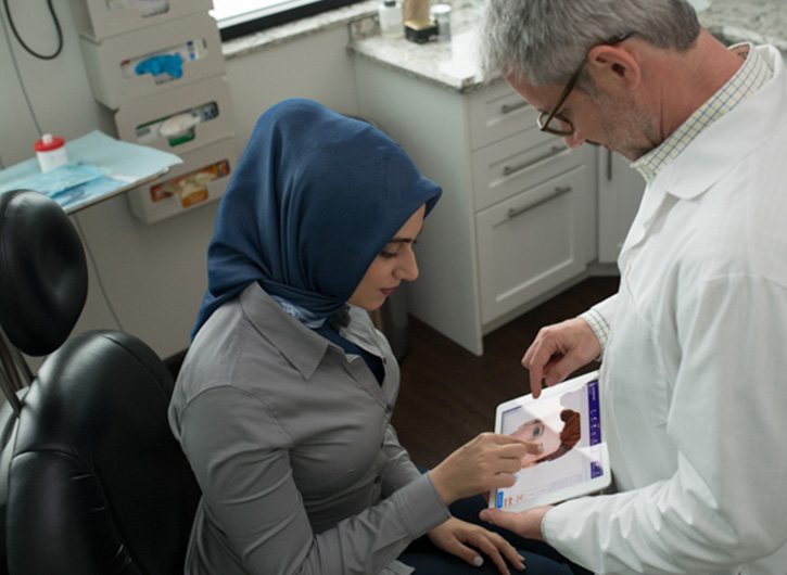 smiling doctor and patient interacting in exam room smiling doctor and patient interacting in exam room
