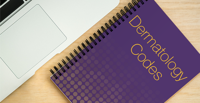 purple dermatology code book next to laptop