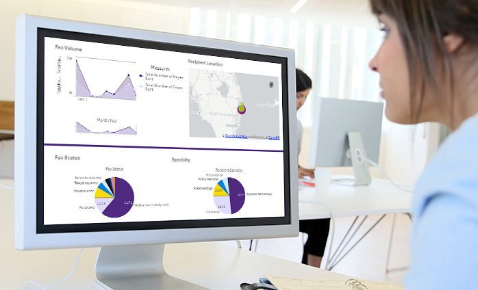 female staff member looking at charts and graphs in analytics on desktop computer female staff member looking at charts and graphs in analytics on desktop computer