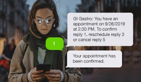 woman with glasses looking at phone with texts from her gastroenterology office