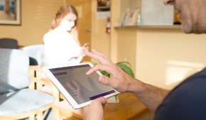 patient in waiting room using modmed Kiosk on iPad