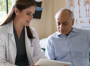 doctor and patient looking at iPad together