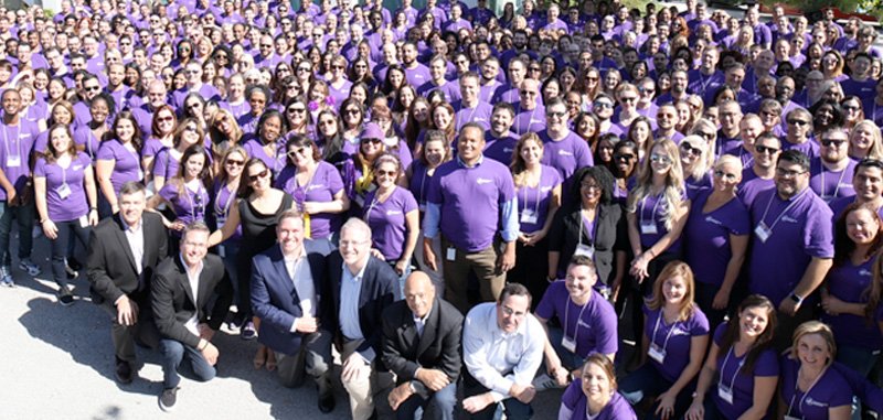 group of Modernizing Medicine employees in purple shirts
