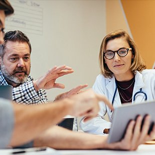 physician with stethoscope typing on a laptop on a gastroenterology portal login screen physician with stethoscope typing on a laptop on a gastroenterology portal login screen