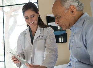 doctor and patient looking at iPad together doctor and patient looking at iPad together