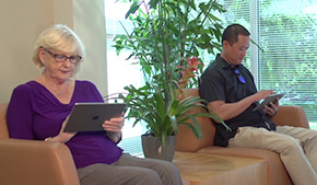 patient in waiting room using ModMed Kiosk on iPad