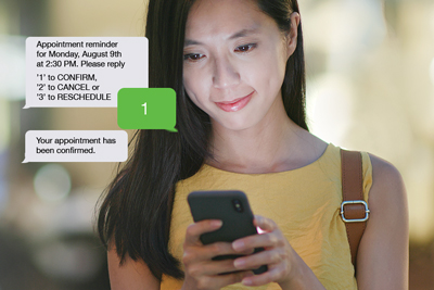 A woman schedules a doctor appointment with her mobile phone.