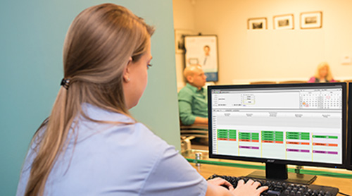 nurse using a computer at her desk