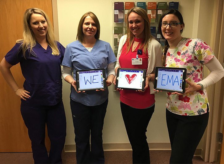 Cayuga Medical Associates holding iPad that says We Heart EMA