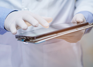 Image of physician using tablet to document notes