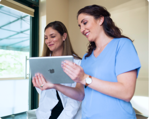 Clinical staff reviewing lab information on an iPad.