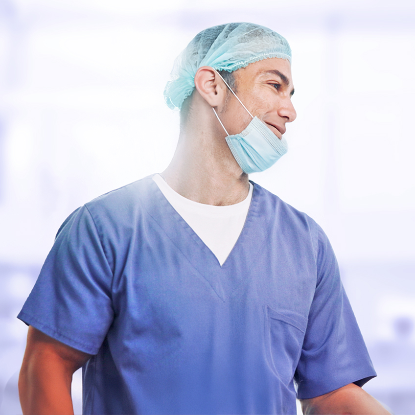 Smiling medical staff member in a clinical setting.