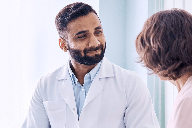 Dermatologist using electronic health record (EHR) software to access automated coding, charting tools, and biopsy settings