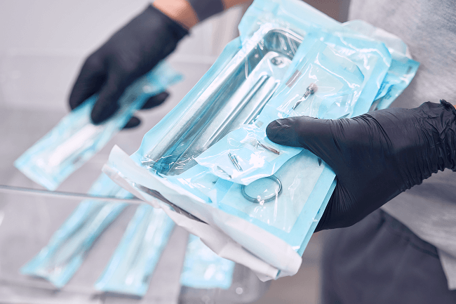 A physician grabs the medical supplies they’ll need for their next procedure.