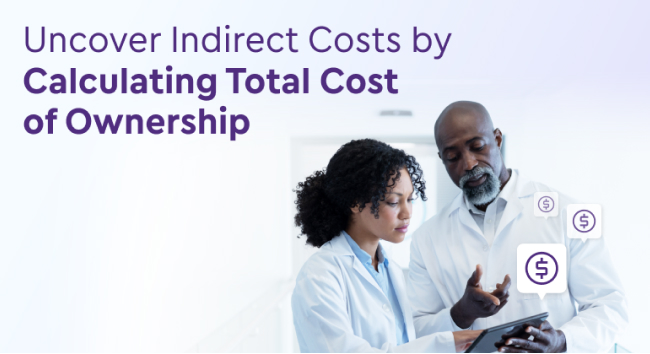 Two physicians in white coats use a tablet to discuss the total cost of ownership for their EHR software.