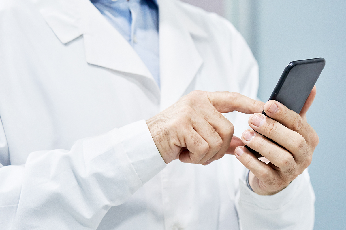 A healthcare provider using their EHR on a mobile phone for added documentation flexibility.