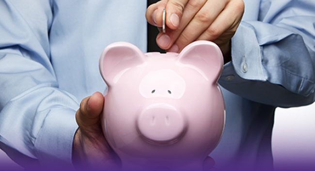 An image of a physician putting a coin into a piggy bank and saving money.