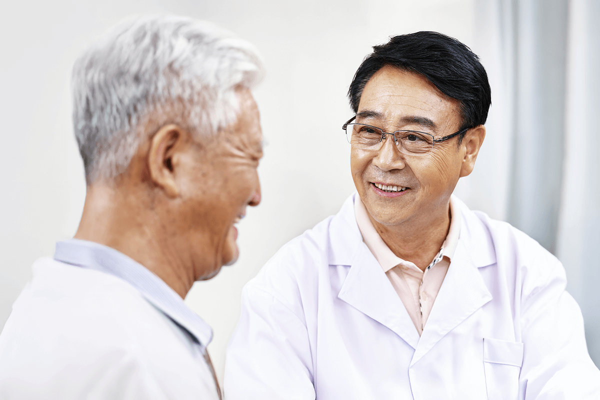 An ophthalmologist speaking with a patient during a routine visit.