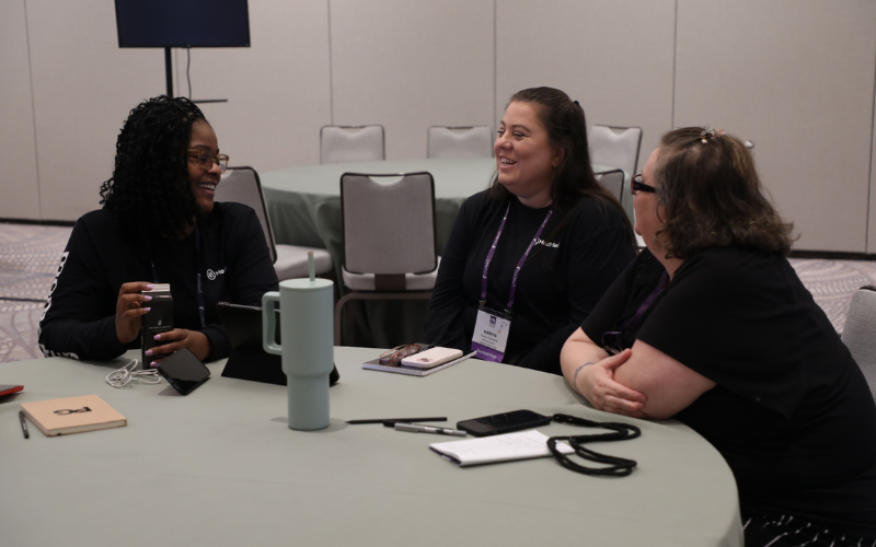 Attendees gather during a roundtable discussion at MOMENTUM.