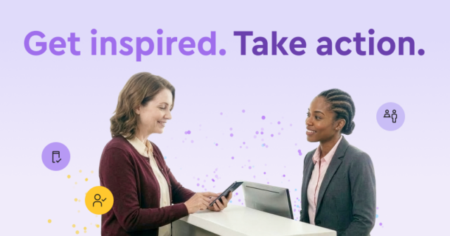 Two women looking down at their devices and smiling.