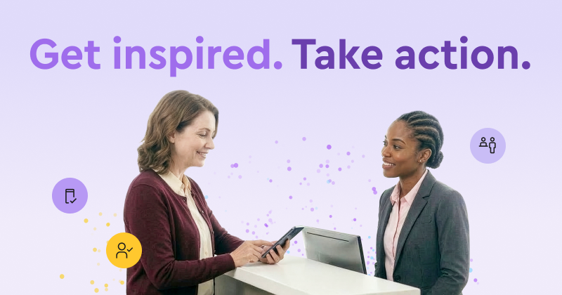 Two women looking down at their devices and smiling.