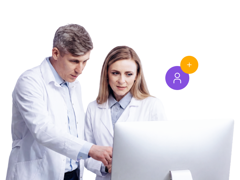 Two healthcare professionals in white coats collaborating at a desktop computer monitor, with floating icons representing a user profile and an add user plus sign.