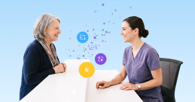 A smiling healthcare worker in scrubs standing behind a desk, warmly welcomes a female patient.