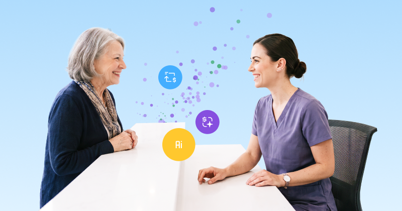 A smiling healthcare worker in scrubs standing behind a desk, warmly welcomes a female patient.