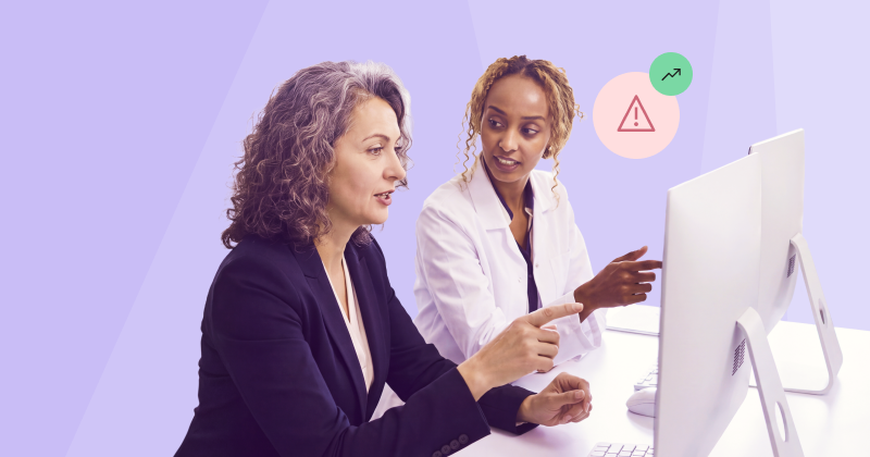 Two women discussing claim denials at a computer.